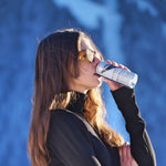 Woman drinking Alpine Bliss. Energy drinks formulated for better skin, hydration, focus and weight loss. Low calorie drinks.